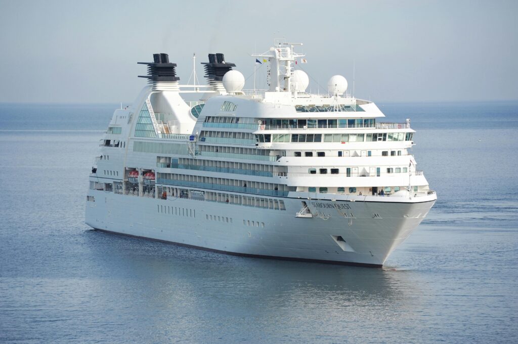 Elegant cruise ship sailing smoothly across tranquil waters under a clear sky.